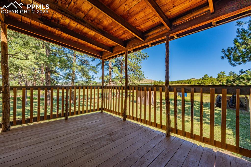 Image 3 of 27: Wooden deck featuring a lawn