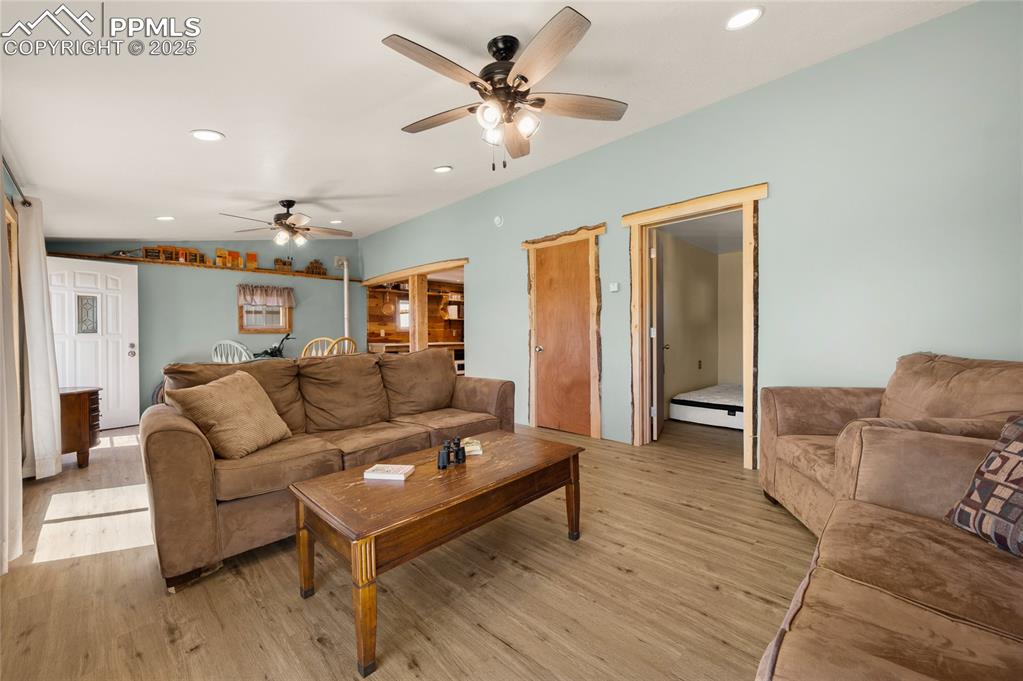Image 8 of 27: Living area with ceiling fan, light wood-type flooring, and recessed lighti