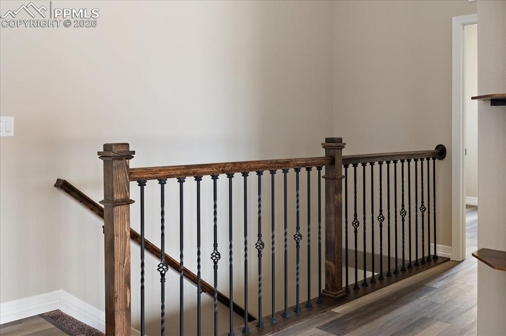 Image 12 of 45: Stairs featuring wood finished floors and baseboards
