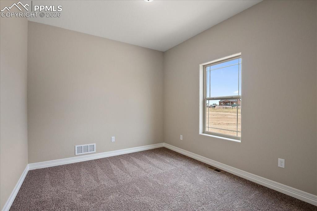 Image 19 of 45: Carpeted spare room featuring baseboards