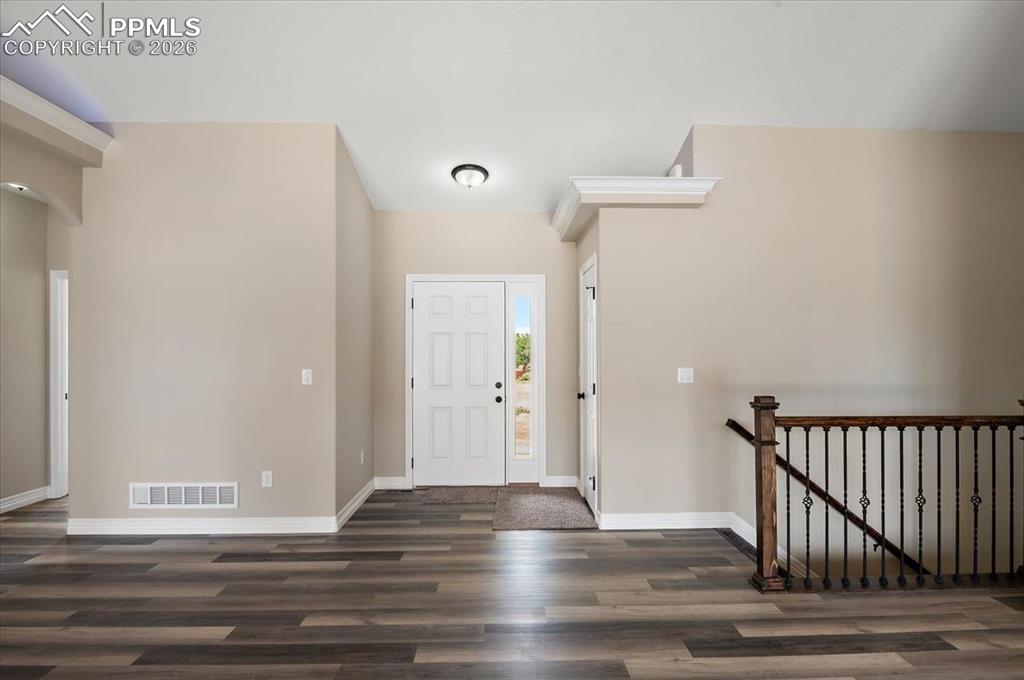 Image 2 of 45: Entryway with baseboards and wood finished floors
