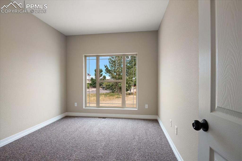 Image 20 of 45: Empty room featuring carpet flooring and baseboards