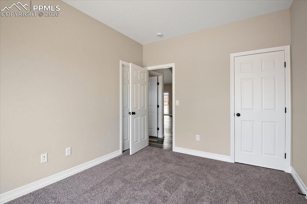 Image 21 of 45: Unfurnished bedroom featuring baseboards and carpet