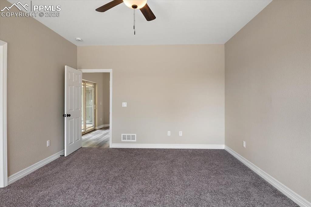 Image 25 of 45: Carpeted empty room featuring baseboards and ceiling fan