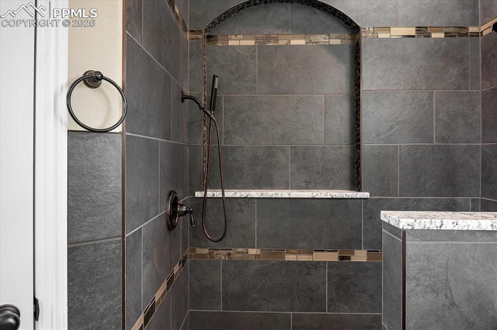 Image 29 of 45: Bathroom with a tile shower