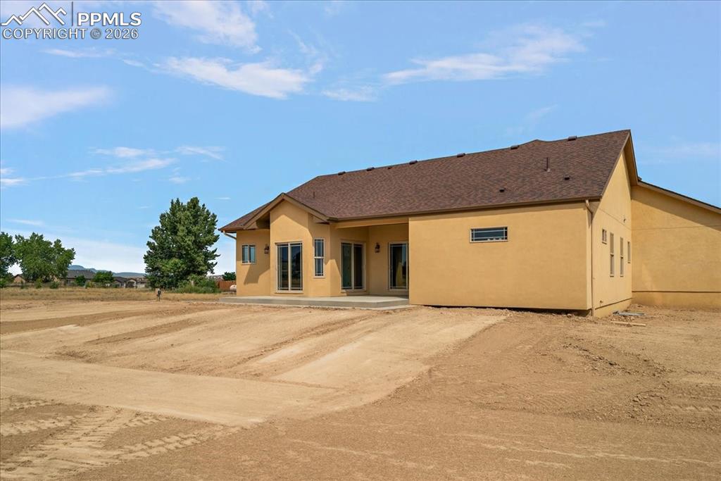 Image 41 of 45: Rear view of house with stucco siding