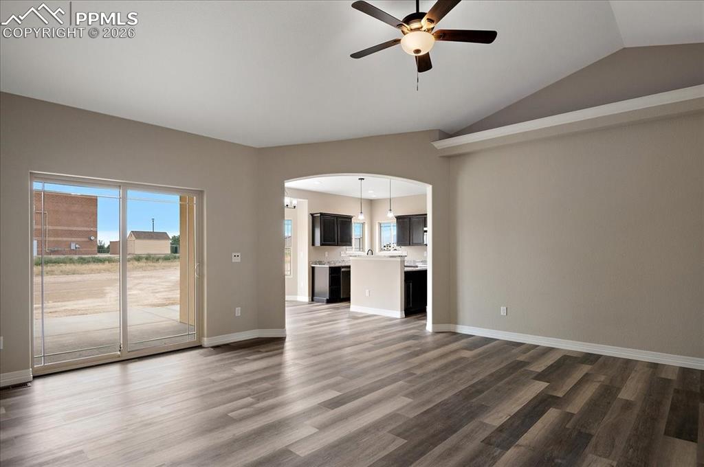 Image 7 of 45: Unfurnished living room featuring healthy amount of natural light, lofted c