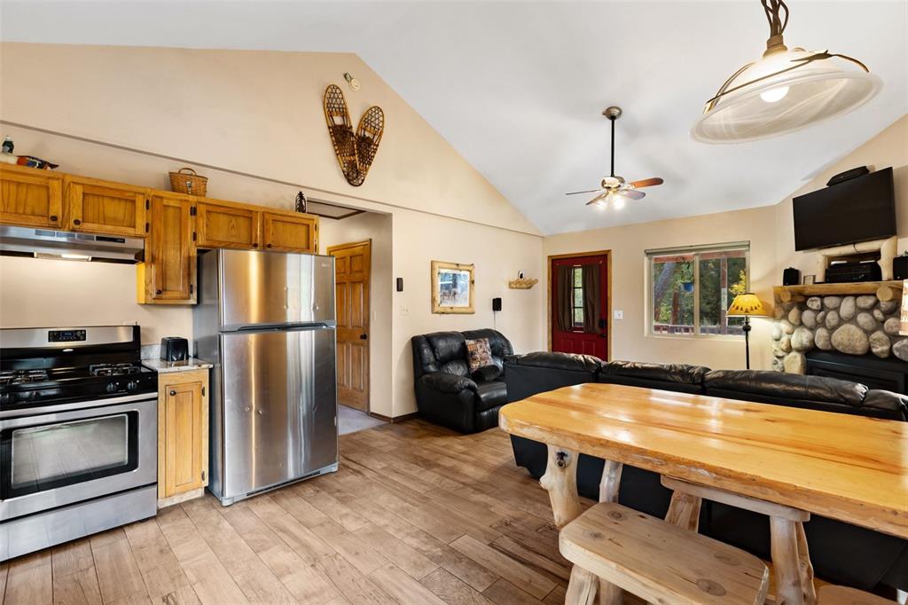 Image 15 of 36: Vaulted ceiling, wood-finish flooring, stainless steel appliances, stone-cl