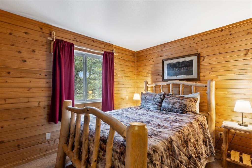Image 22 of 36: Wood-paneled walls with a light wood finish