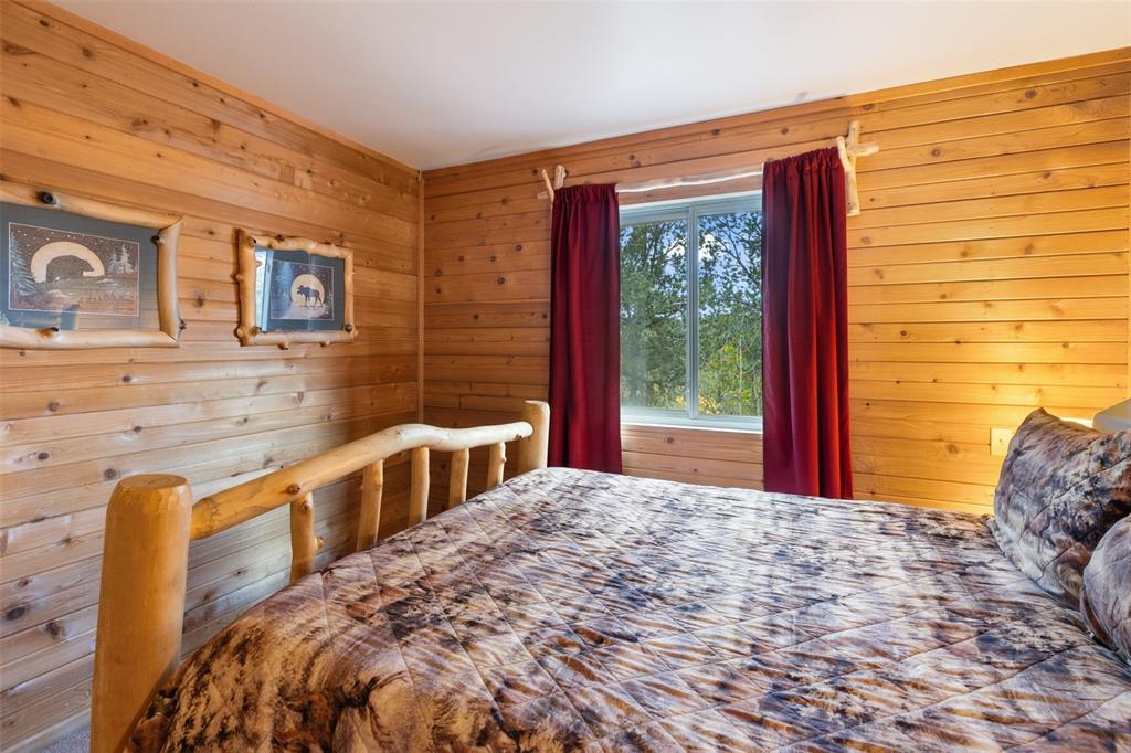 Image 24 of 36: Natural wood paneling throughout, built-in window with outdoor scenery, and