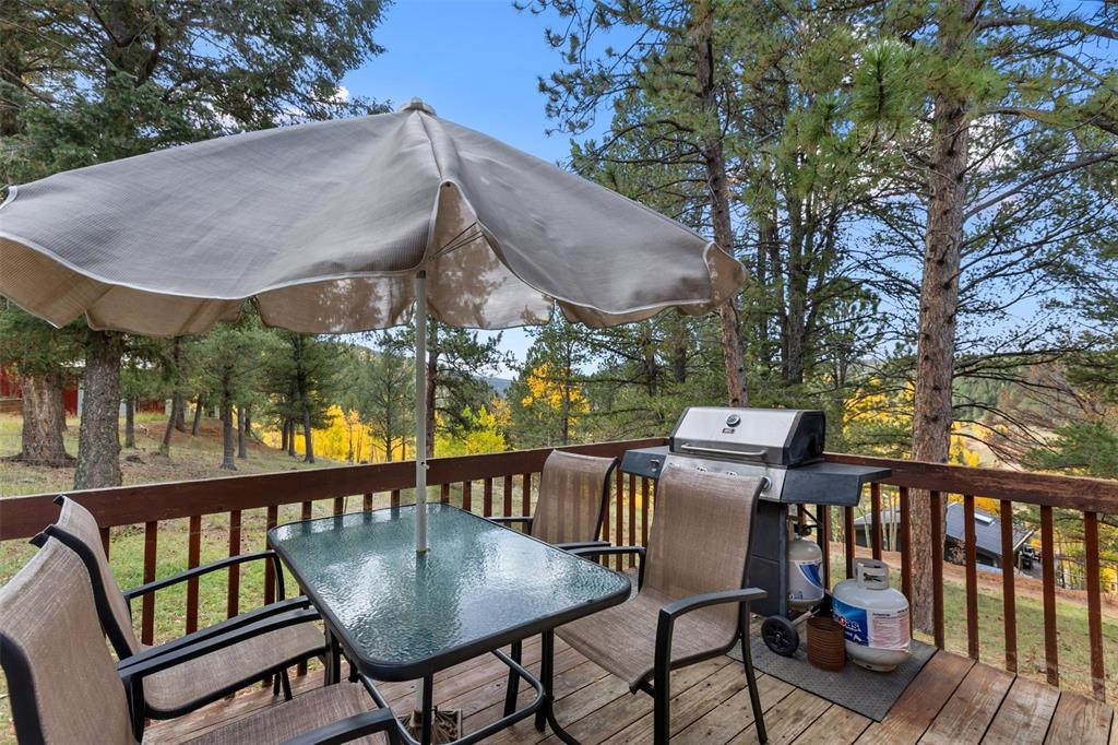Image 28 of 36: Wood-finish deck with a wooden railing