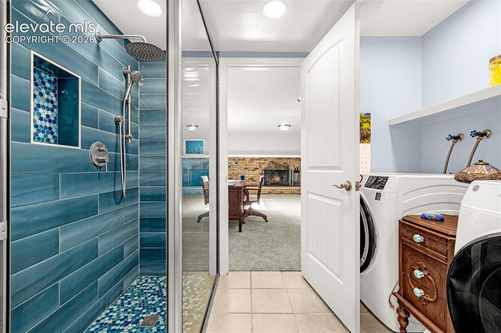 Image 14 of 40: Bathroom featuring a dark wood vanity with a granite countertop, a circular