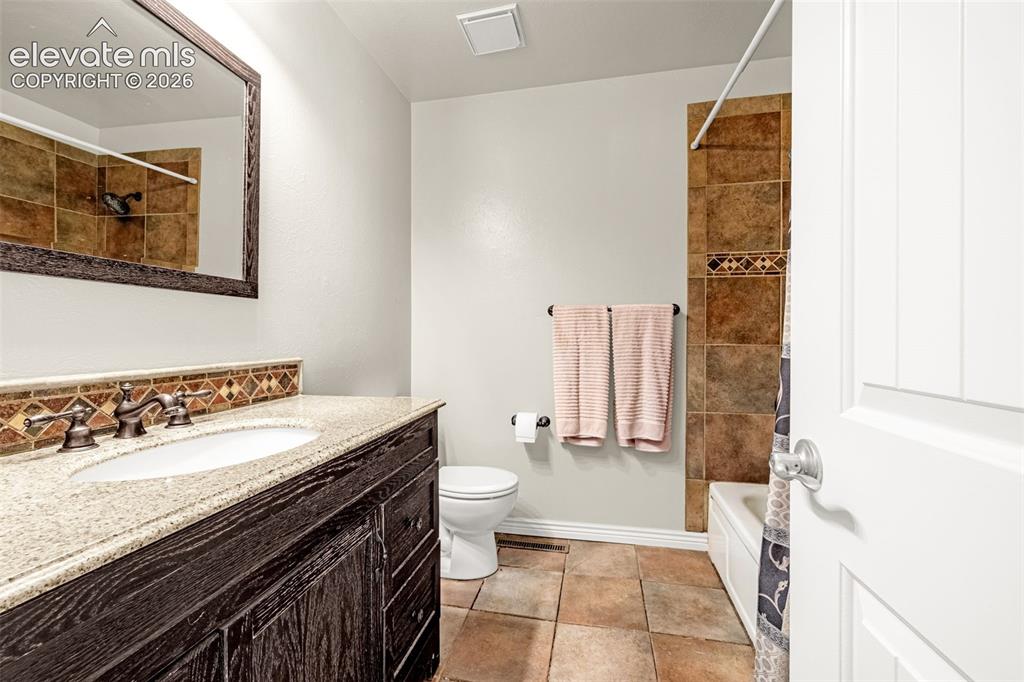 Image 19 of 40: Room featuring a ceiling fan with integrated lighting, a double-paned windo