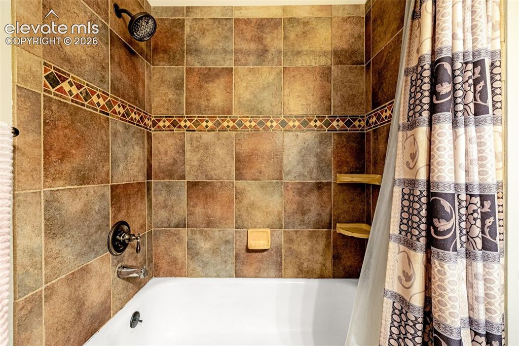 Image 20 of 40: Upper level bathroom featuring a dark wood-finish vanity with an undermount