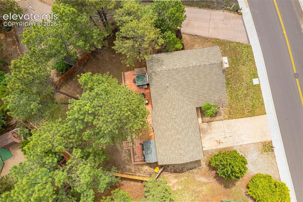 Image 31 of 40: Tri-level-style residence featuring a brick and siding exterior with a prom