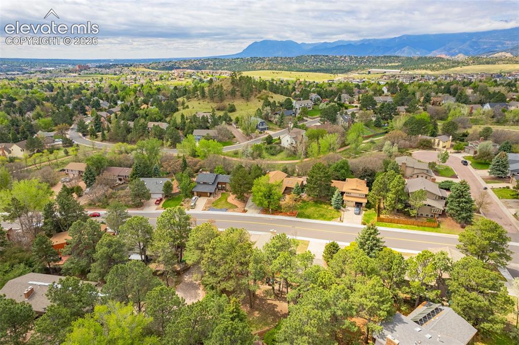 Image 32 of 40: Expansive property featuring mature evergreen trees, a shingle roof, a conc