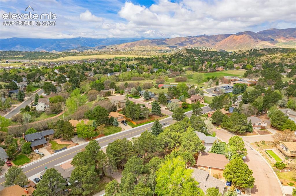 Image 33 of 40: Aerial perspective showcasing a residential area with mature trees and vari