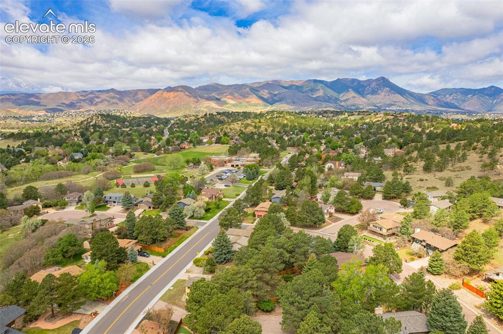 Image 34 of 40: Residential area featuring established homes, mature trees, and paved roads