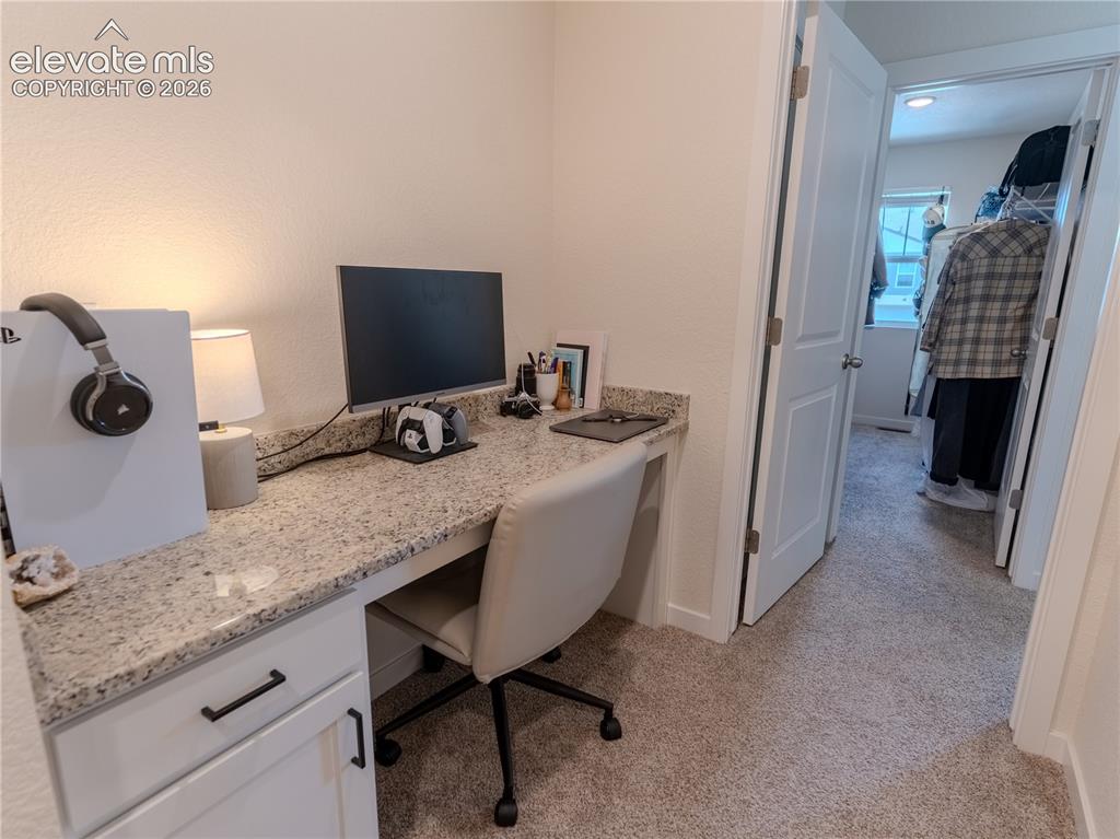 Image 18 of 46: desk area with view of Primary closet 