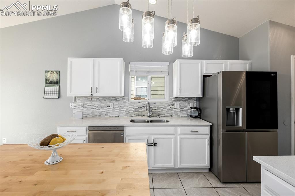 Image 13 of 37: Updated Kitchen with beautiful white cabinetry and quartz/butcher block cou