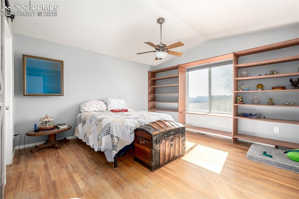 Image 14 of 37: Main Level Primary Suite with Built In Books Cases overlooking the open spa