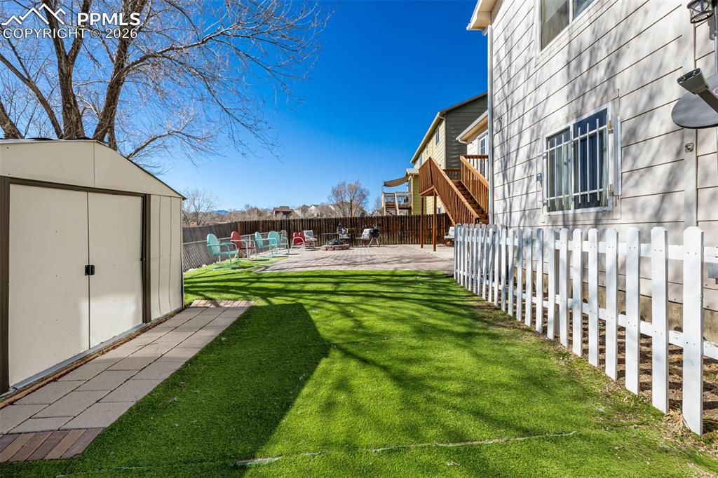 Image 29 of 37: Xeriscaped Backyard and Spacious Storage Shed