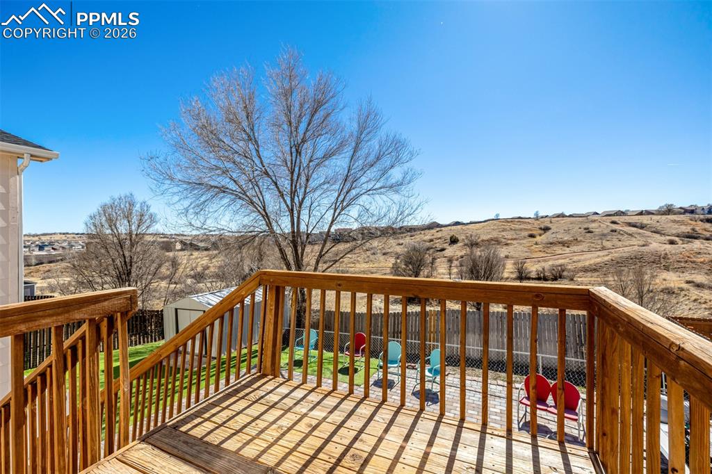 Image 33 of 37: Deck overlooking backyard and open space with trails