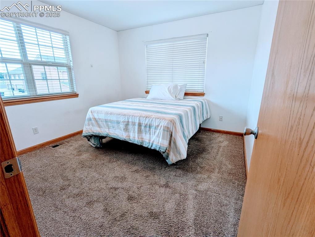 Image 10 of 19: Carpeted bedroom 2featuring baseboards