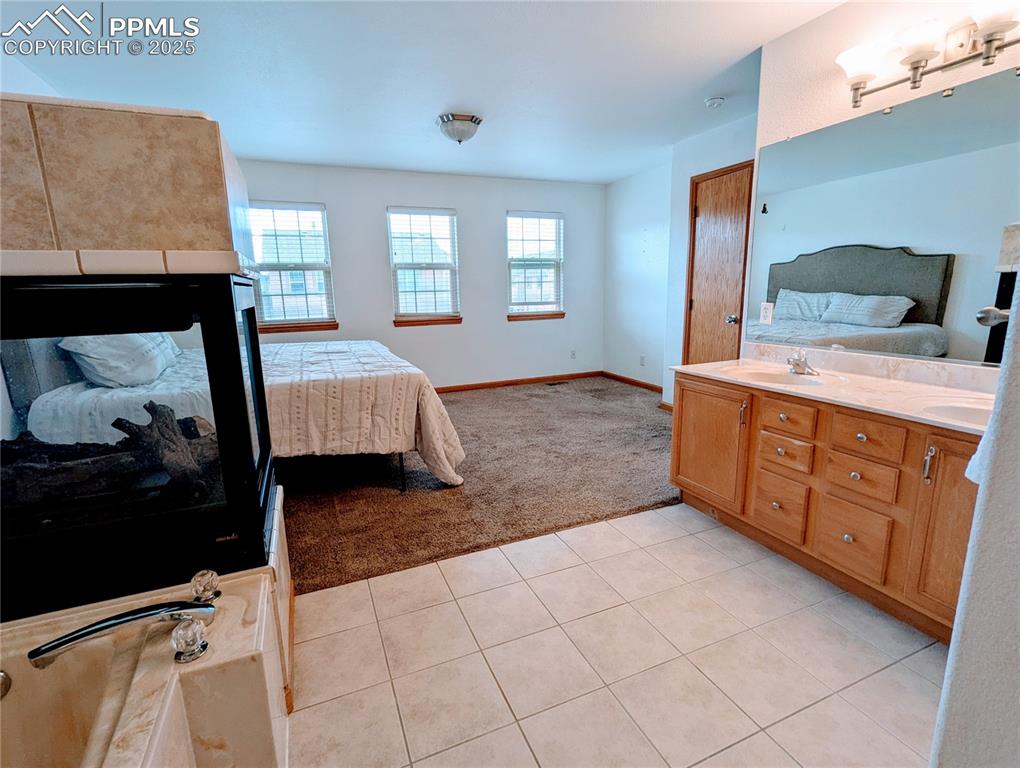 Image 16 of 19: Full bathroom with ensuite bathroom, tile patterned flooring, double vanity
