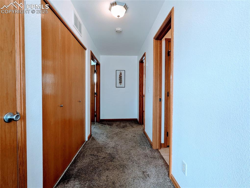 Image 6 of 19: Hall with light carpet and baseboards