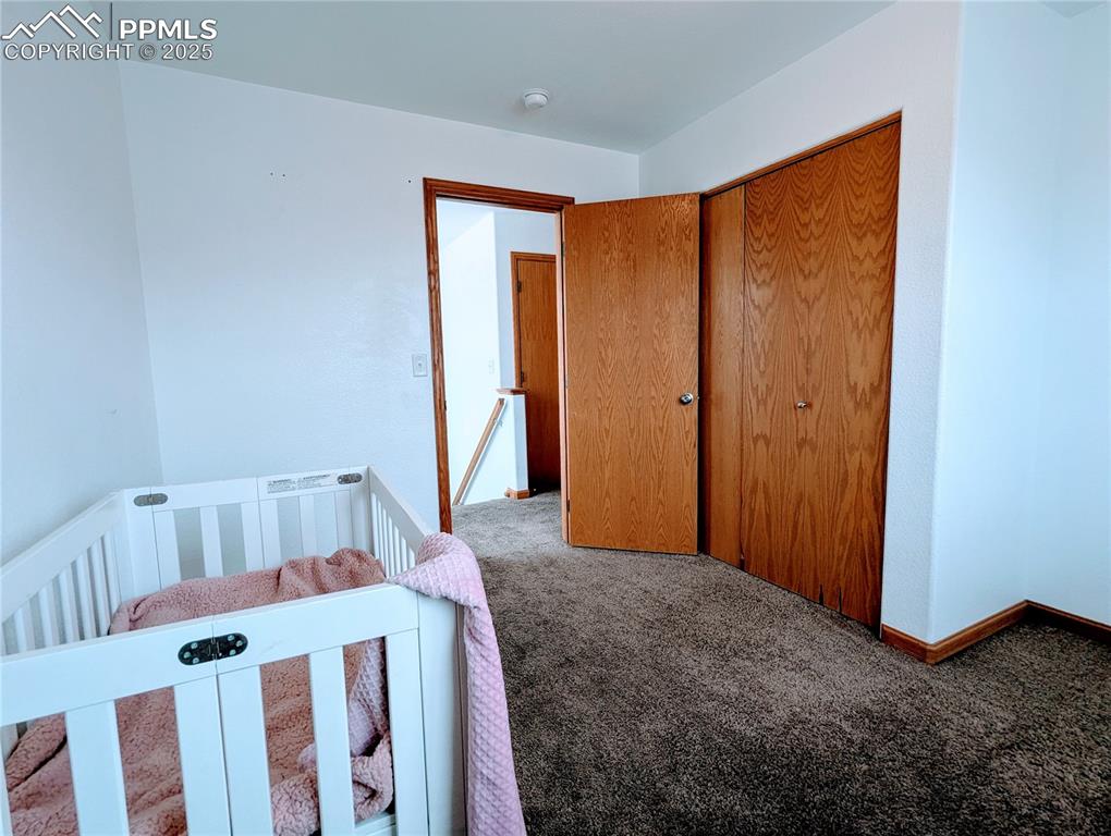Image 9 of 19: Carpeted bedroom featuring baseboards