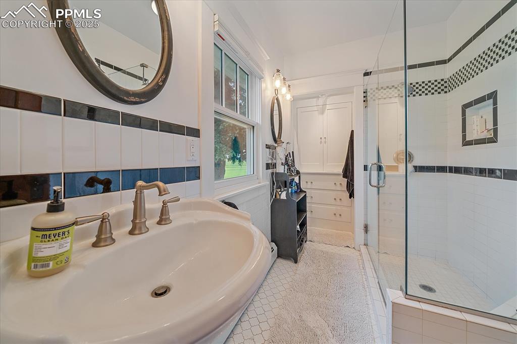 Image 19 of 44: Full bath featuring a stall shower and a sink