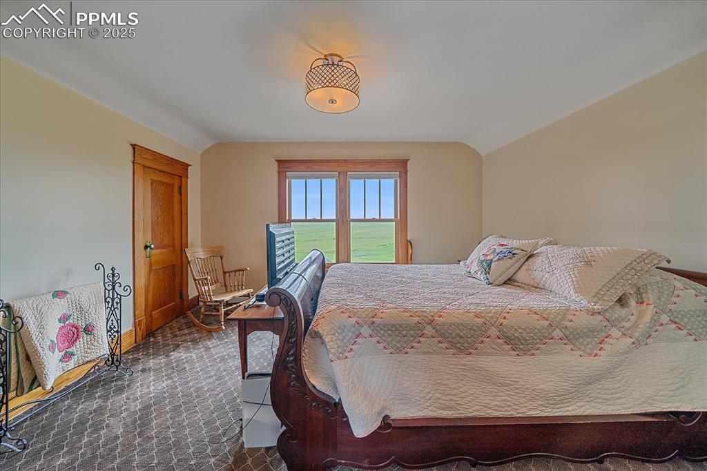 Image 21 of 44: Bedroom with vaulted ceiling