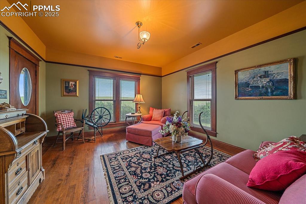 Image 29 of 44: Living room featuring wood finished floors and baseboards