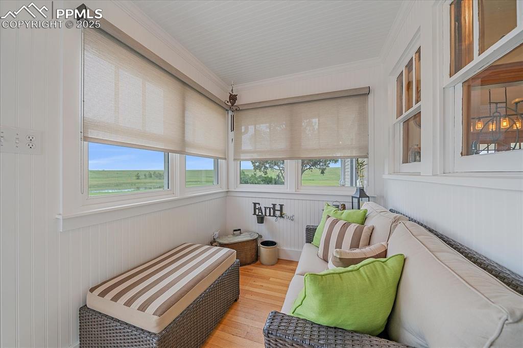 Image 6 of 44: Sunroom featuring healthy amount of natural light, wood finished floors, wo