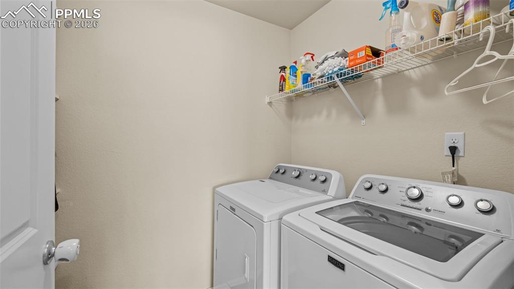 Image 13 of 28: Laundry room featuring washer and clothes dryer