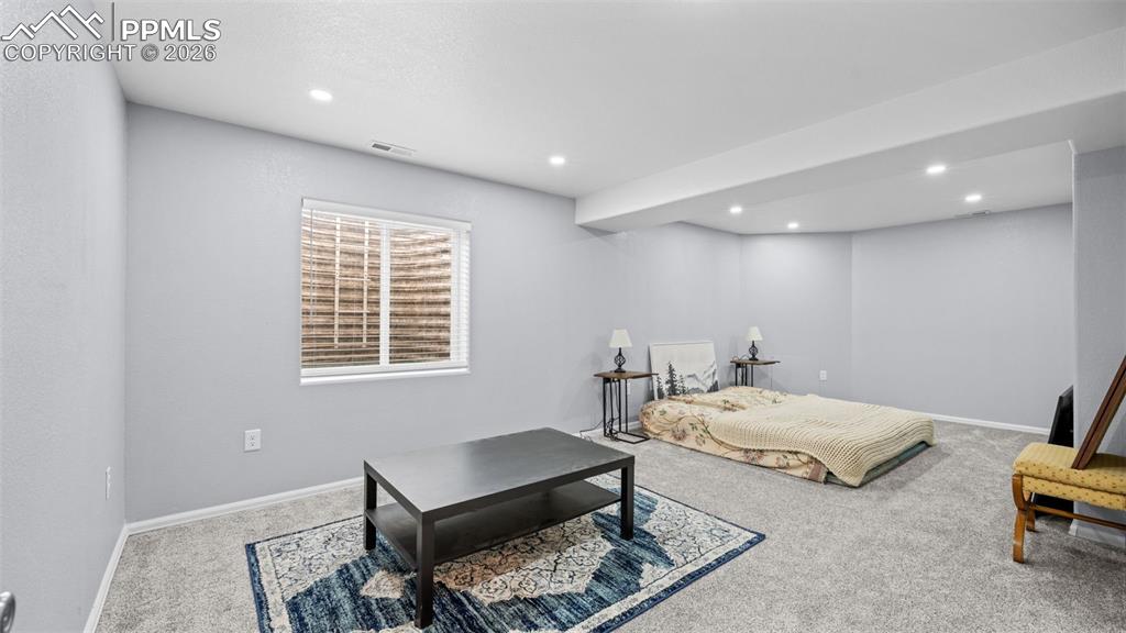 Image 18 of 28: Bedroom featuring light carpet and recessed lighting