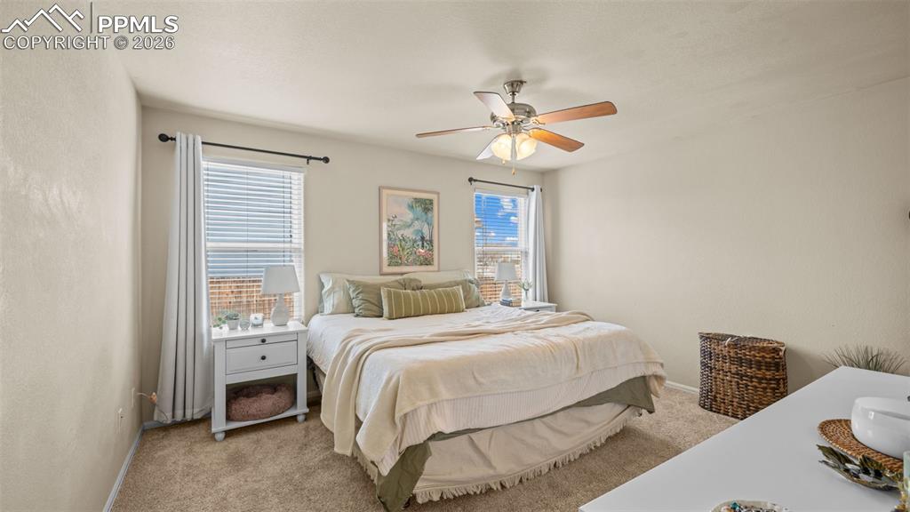 Image 19 of 28: Bedroom featuring light colored carpet and a ceiling fan
