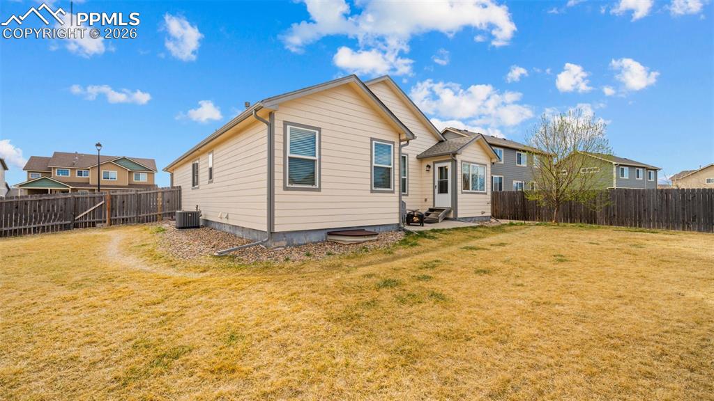 Image 24 of 28: Rear view of house featuring a patio area and a fenced backyard
