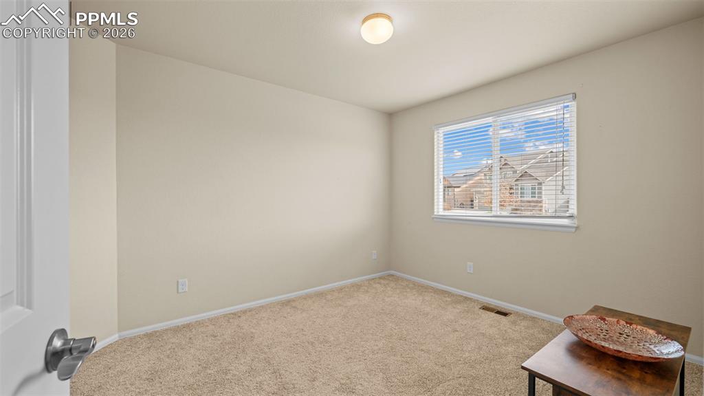 Image 7 of 28: Spare room featuring light colored carpet and baseboards