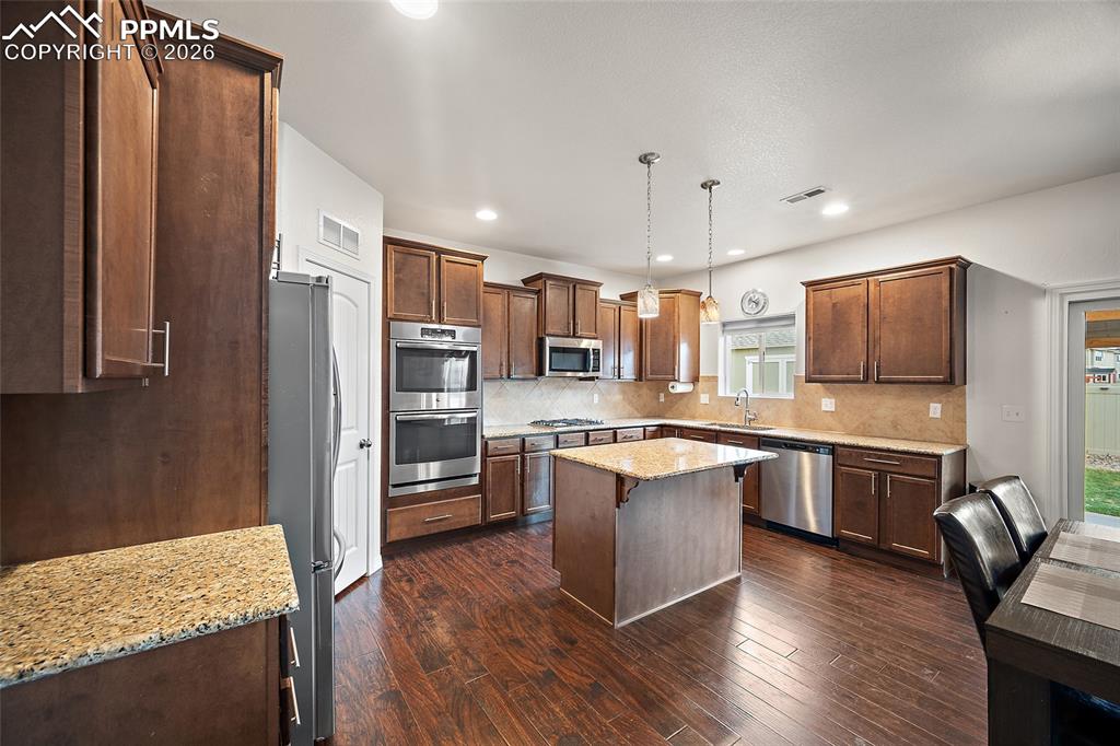 Image 7 of 37: Breakfast bar with gorgeous granite counter tops. 