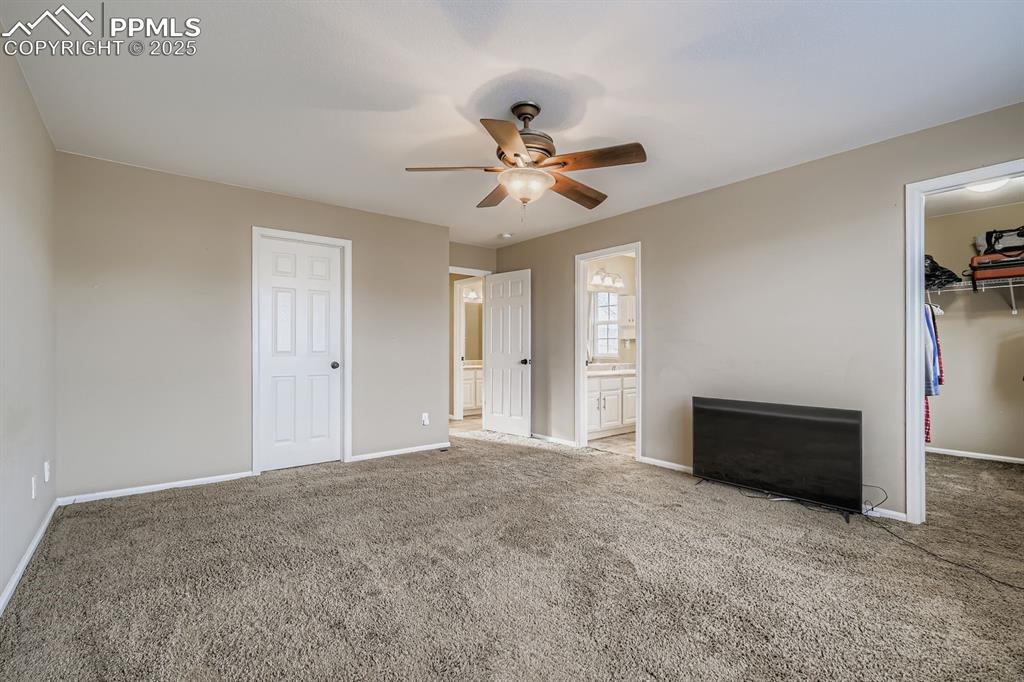 Image 14 of 27: Primary bedroom with two walk-in closets