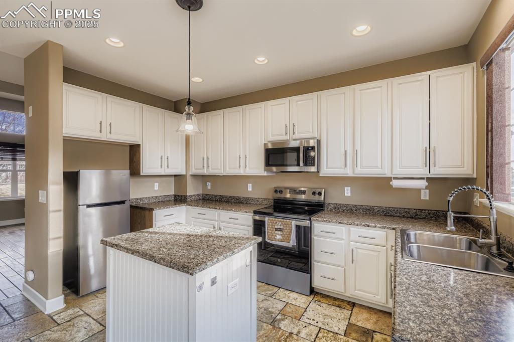 Image 7 of 27: White cabinets with brand new oven and microwave