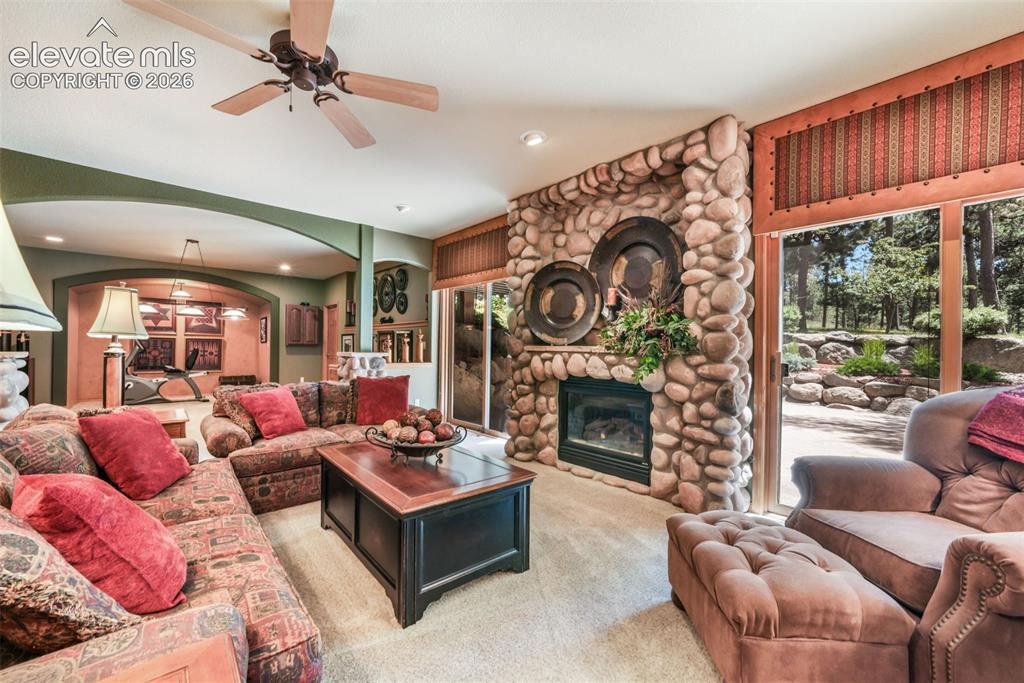 Image 30 of 50: Gas Fireplace with Floor to Ceiling Stone Surround