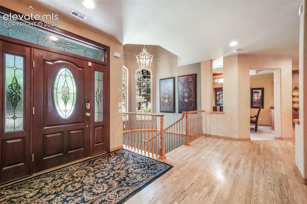 Image 6 of 50: Spacious Entry with Natural Hardwood Floors