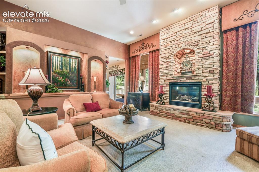 Image 7 of 50: Gas Fireplace with Floor to Ceiling Stone Surround