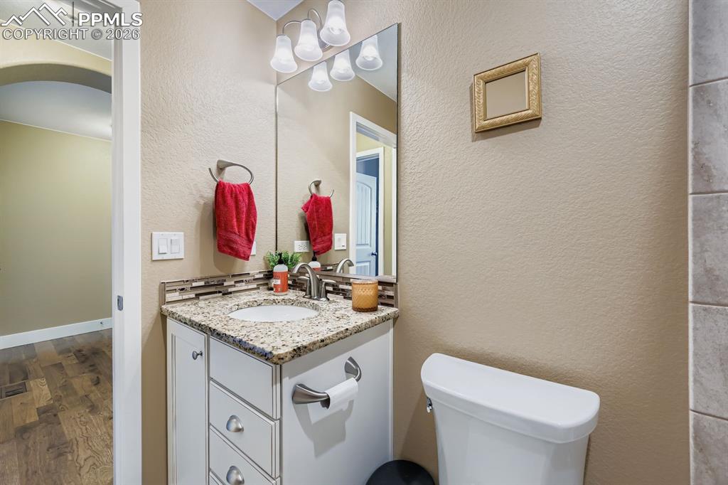 Image 15 of 33: Main level full bath located next to secondary bedroom