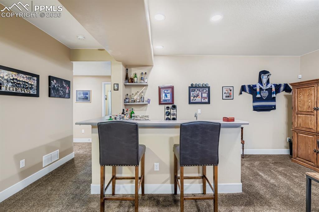 Image 19 of 33: Basement family room wet bar