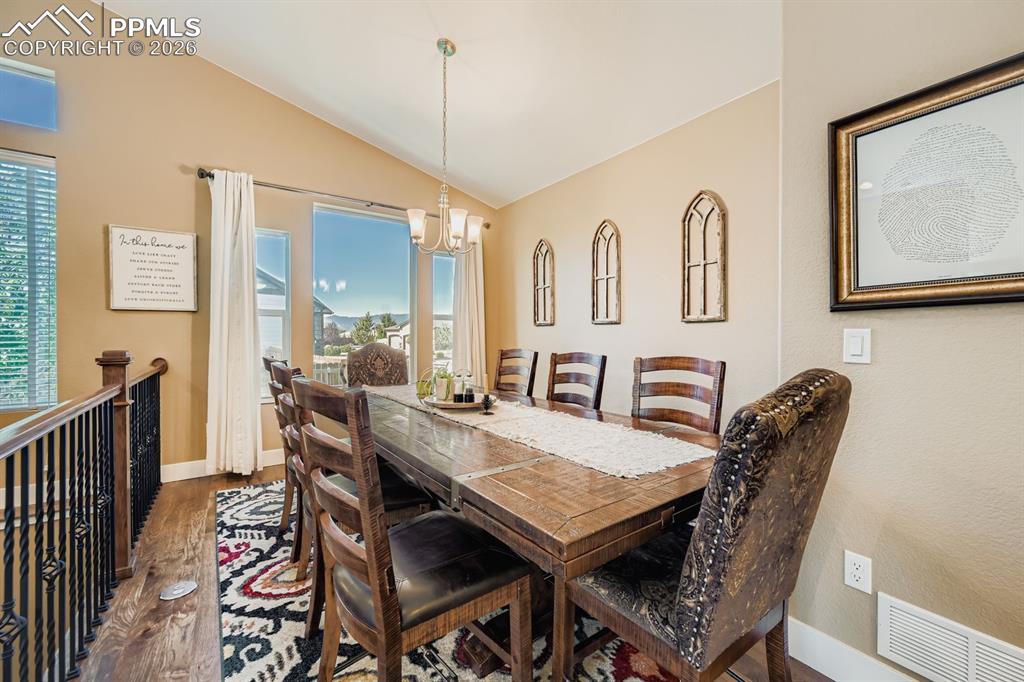 Image 3 of 33: Large formal dining is one of two eating areas- vaulted ceilings with plent