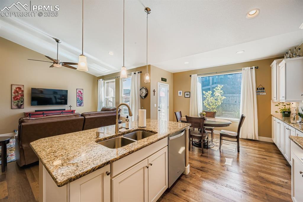 Image 8 of 33: Solid slab granite counters with plenty of storage, workspace and pantry